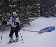 Cathy Susan of Ann Arbor, Michigan pulls her sledge across Agler County's Long Lake during a 6-day, January '05 winter-camping trip south of the Pictured Rocks National Lakeshore (Photo courtesy of Mary Powell of Flint, Michigan)