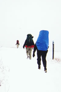 Hikers trek through late season snowfall