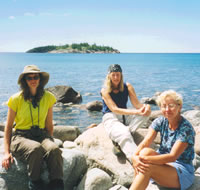Sue, Gail, and Mary enjoy a break along the shoreline