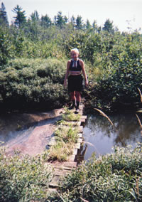 Mary Powell of Flint examines an old foot bridge across the West Branch of the Fox River