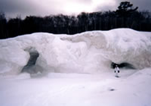Mary Powell explores the ice formations along the shore of Lake Superior