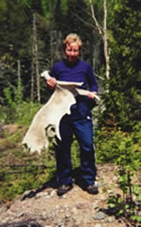 Mary Powell of Flint holds a huge moose shovel she found in the heart of Lake Superior Provincial Park